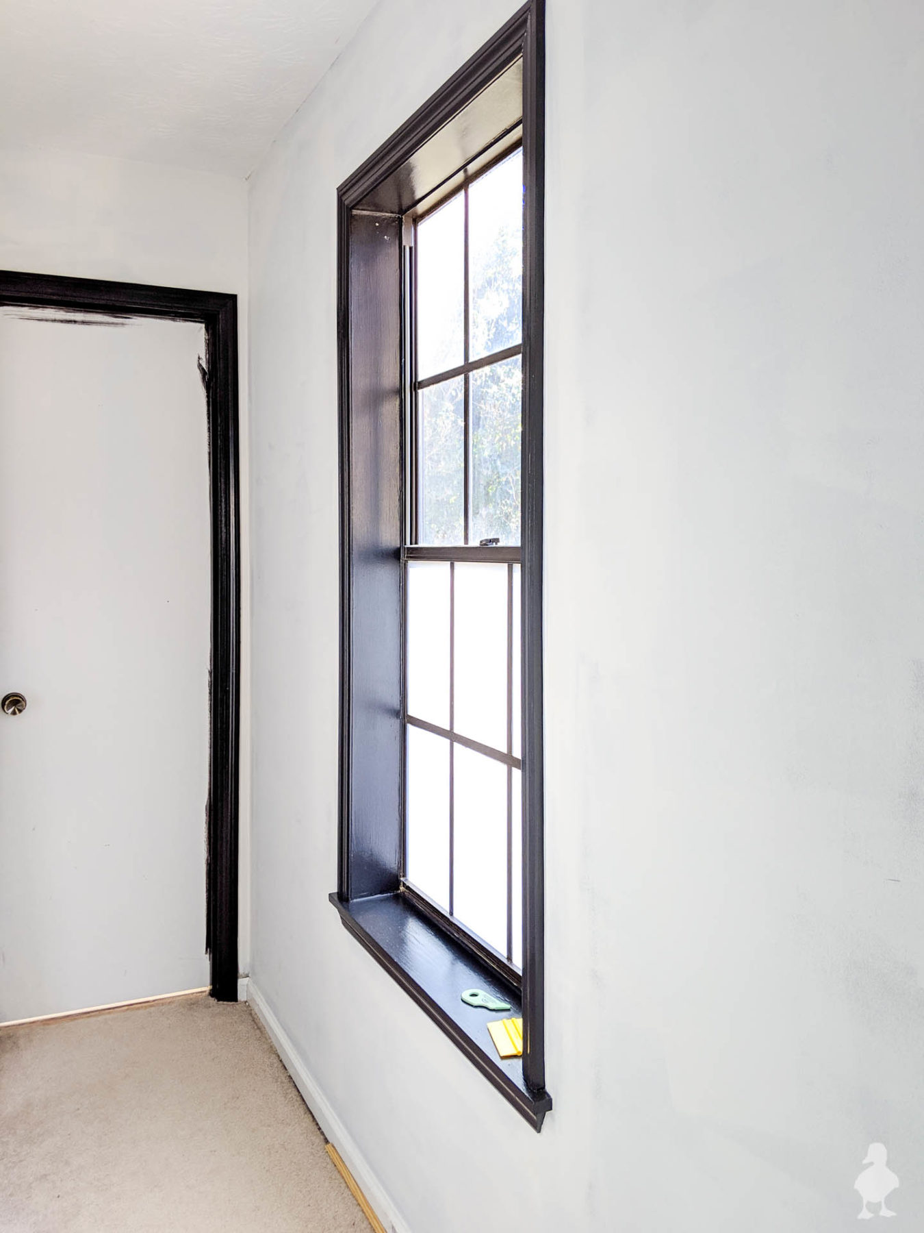 master bedroom hallway window with new window film - tricorn black paint