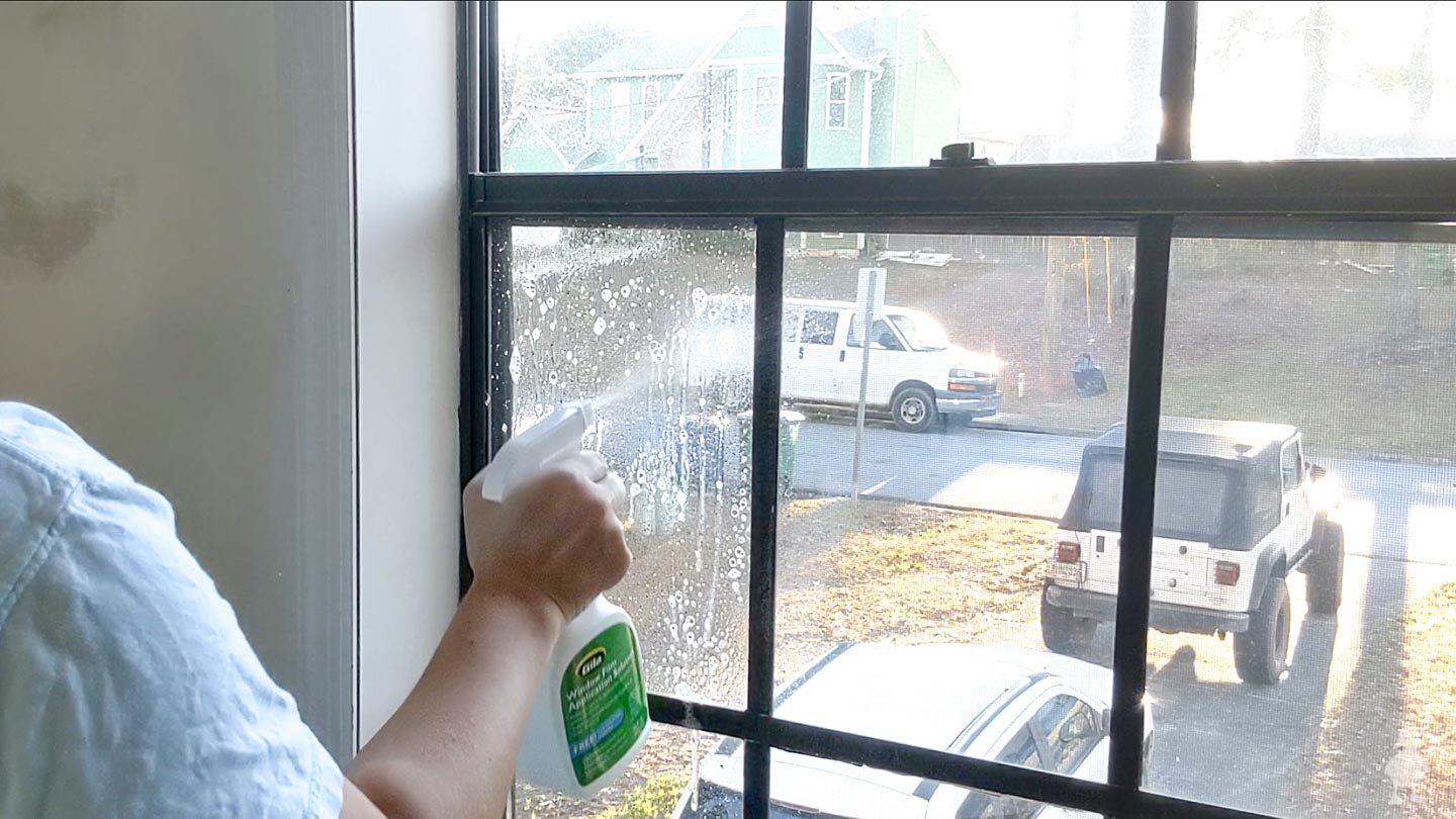 spray film solution on window