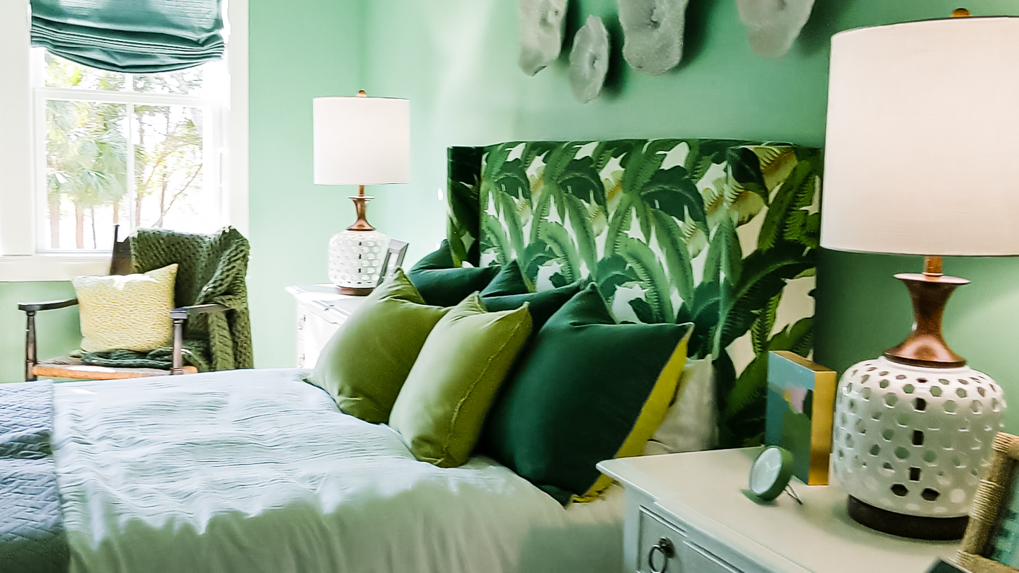 green bedroom with palm front print headboard