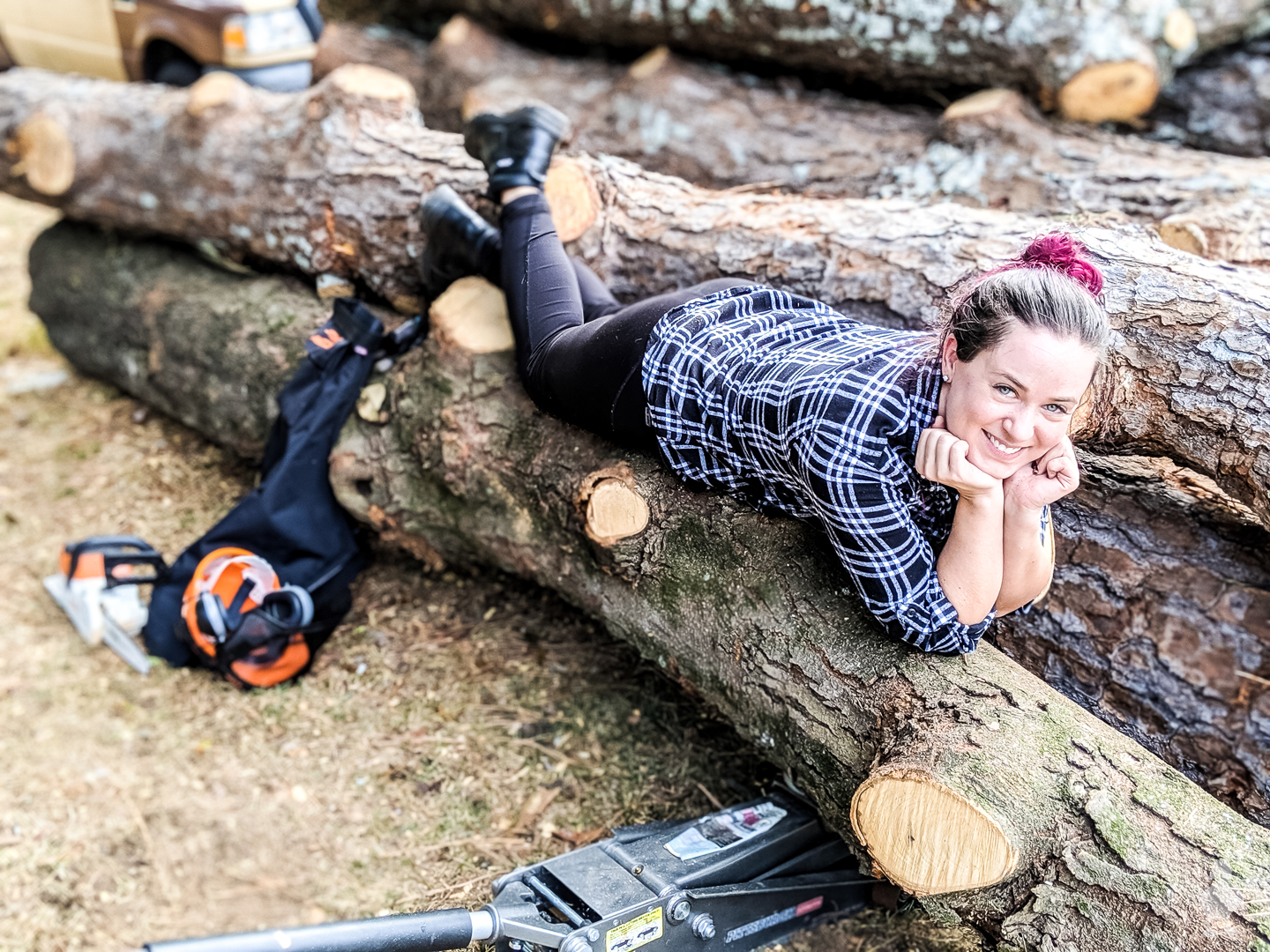 Sarah laying on wood logs