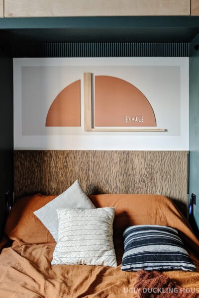 murphy bed nook reveal - exhale rust arch color block art and carved wood headboard with neutral bedding and rust coverlet