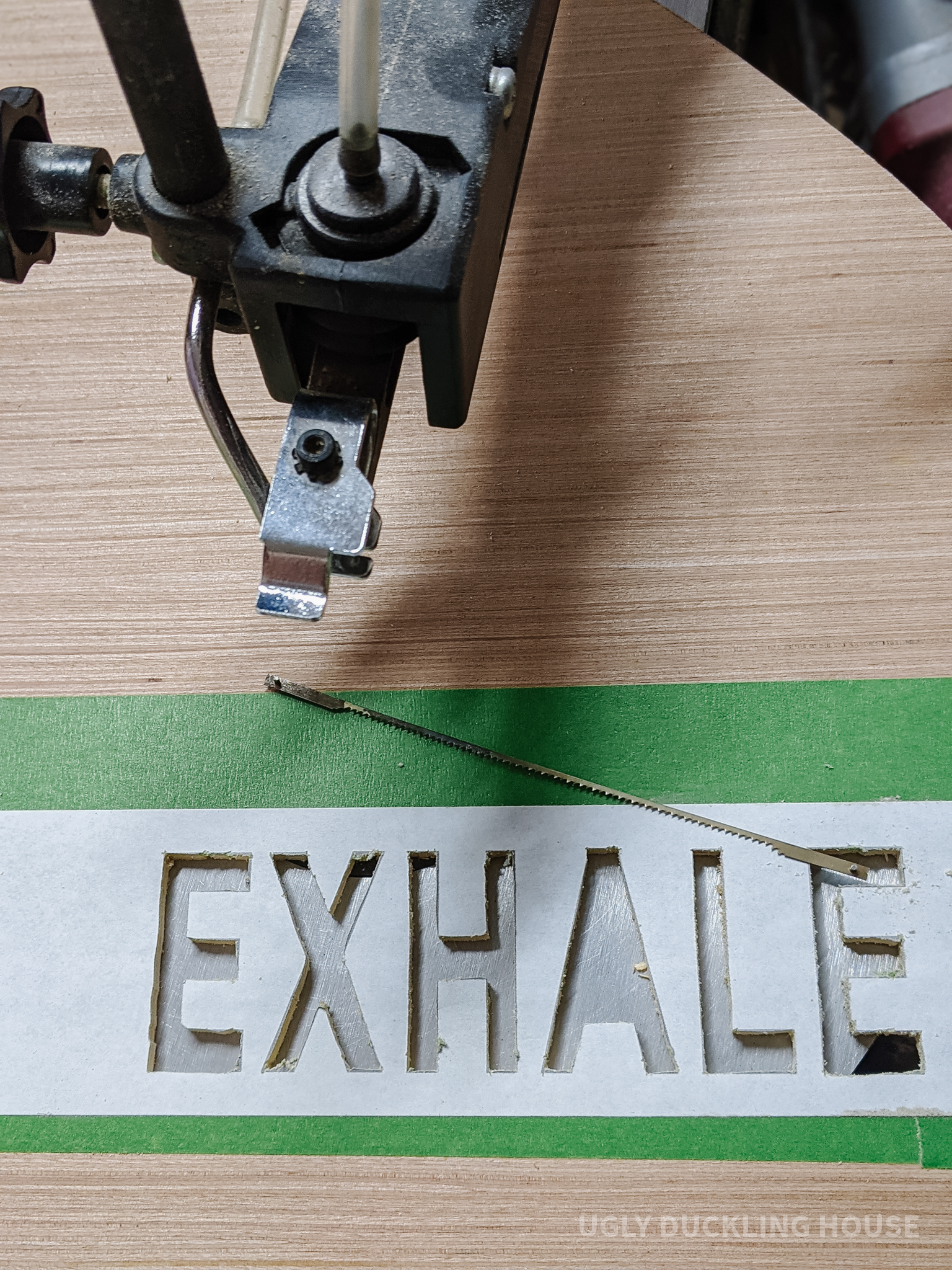 cut out the word "exhale" using a scroll saw